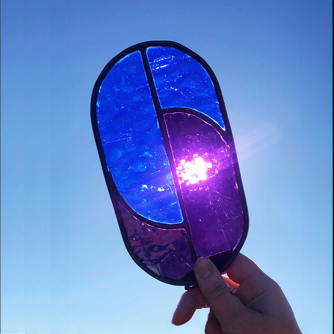 sun backlights this ultramarine blue and rich purple suncatcher